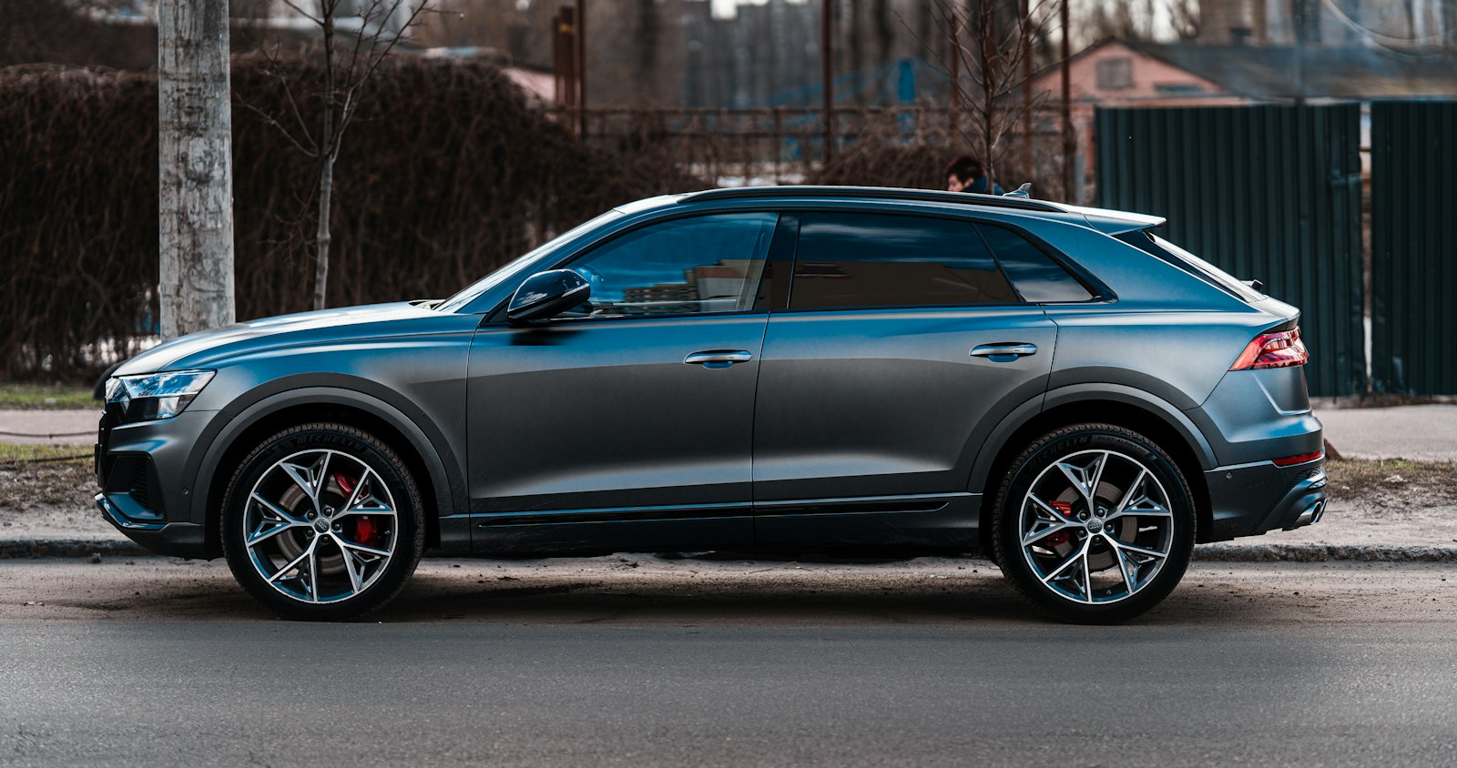 Blue crossover driving on a paved road