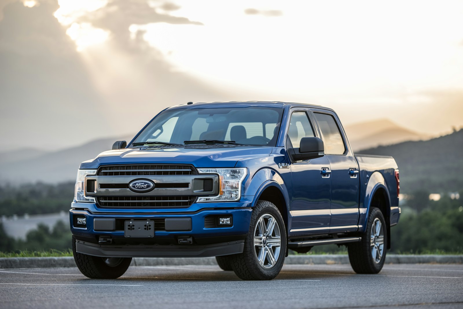 Blue pickup truck parked on an empty road